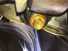 This bolt faces outwards from the car, bigger than the other side bolt, I've read its torqued to 100-101ft lbs