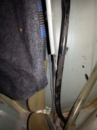 Drain tube to gas tank neck spillover pocket. Clear tube on right is for moonroof drain.