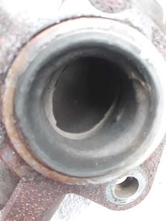 View looking down rear port right flange side..the OEM did a poor job transitioning to the tube below.(welded perpendicular to pipe)  The exhaust flow snags and creates turbulence. Grinding the lower tube out of the flow path should offer improvement.
