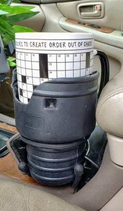 a view from the driver's seat.  An oversized coffee mug sits firmly in place.