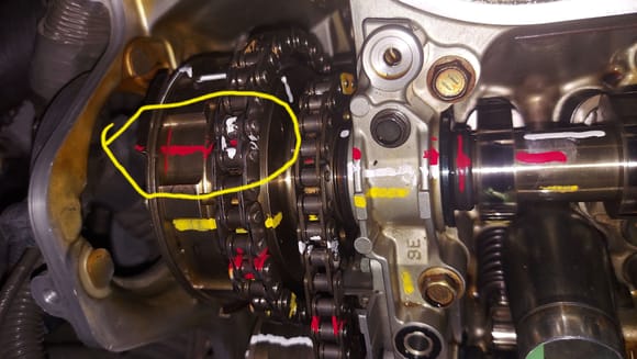After rotating the crankshaft the white marks on the chain were at the red marks on the sprocket. 