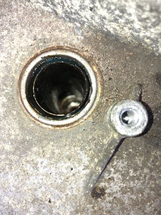 The spark plug well looking rather oily on the top rim