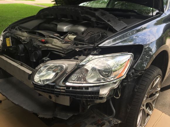 Three mounting bolts removed from the headlight and it will come loose.