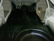 After priming and seam sealing the inside of the tub of the car and the entire undergear were treated with a total of 4 kits of truck bed liner.  This aids in rust protection as well as sound and heat transfer.