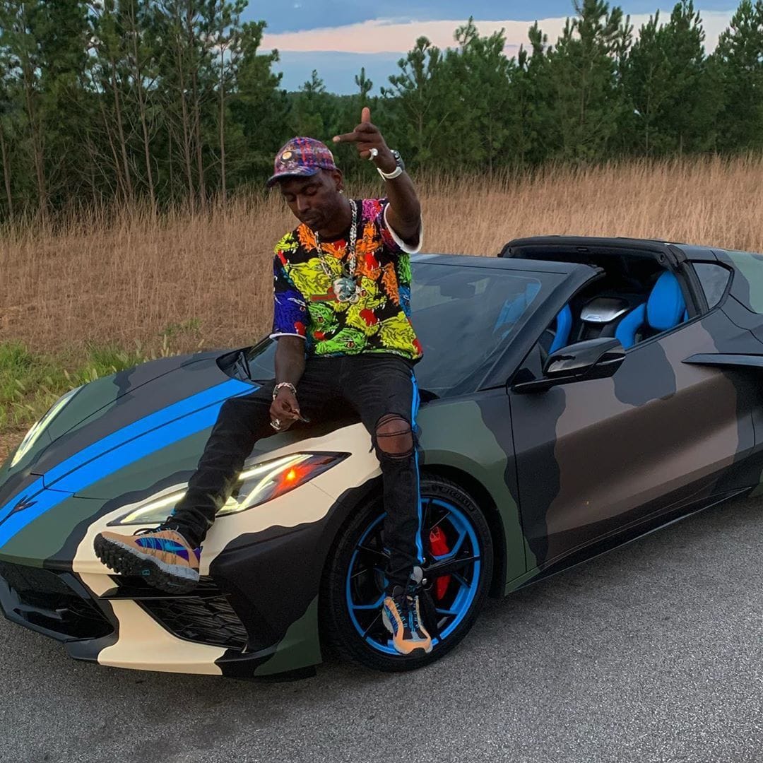 young_dolph_sits_atop_his_corvette_in_a_gucci_sweatshirt_and_hat_amiri_jeans_and_nike_air_humaras_bc022142b55e3992aea4eb6066609ab6b581577c.jpg