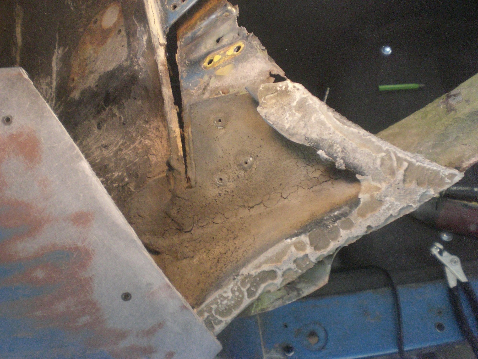 Once the upper fender tip was cut and removed, its bonding assembly was revealed.  Its attached to the metal outer corner with 3 rivets.