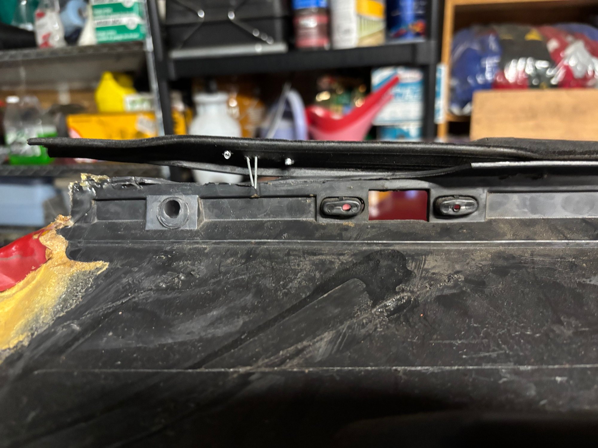 Broken plastic that is supposed to hold the top of the panel tight to the door which gets the inside sweeps snug against the glass.