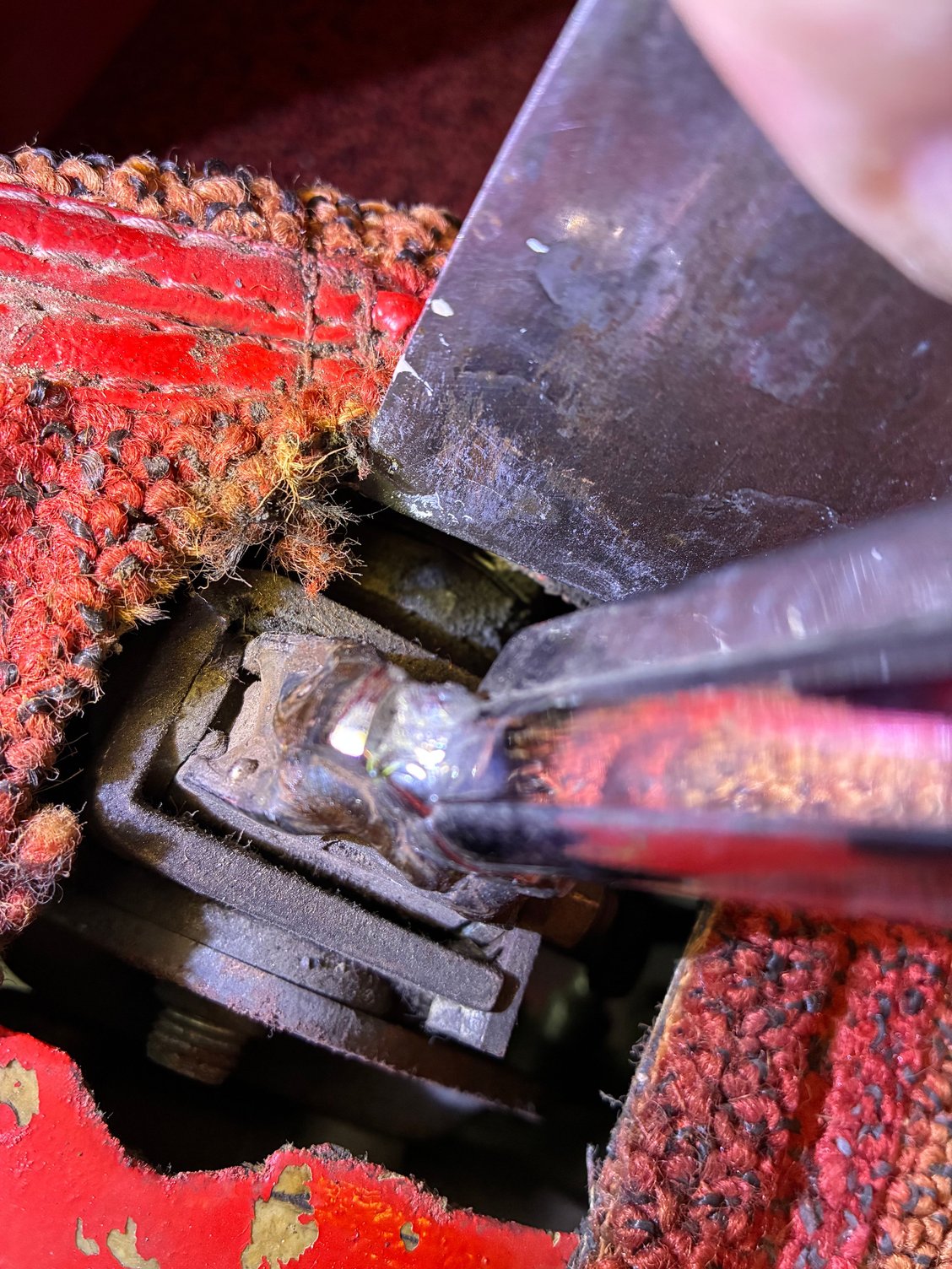 Putty knife holding carpet to see the three arms. 