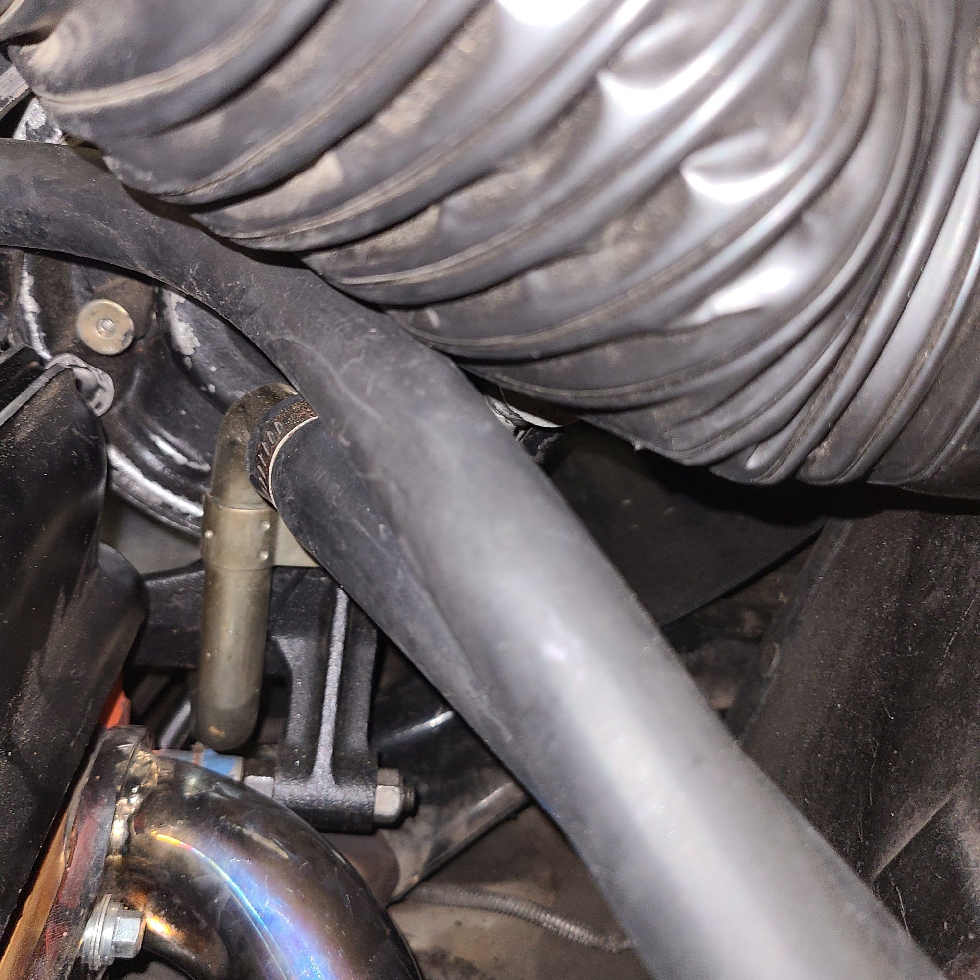 Keeps hoses away from hot header tubes