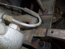 I ended up using a putty knife to keep the bolt head below the top inside of the trailing arm while I assembled things. Just a note for anyone thinking of adding spacers to the top of the bolt.
