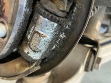Parking brake adjuster wheel.