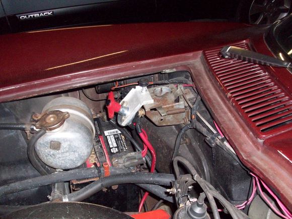 Homemade bracket to hold it to the hood latch. No positive vs negative discussions please.