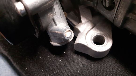What is  the hole in the choke housing with the white stuff in it? This is a 670 Holley Avenger which I bought new and has been used on my car for the last 45000 miles. I never noticed the white stuff before. Carb works fine.