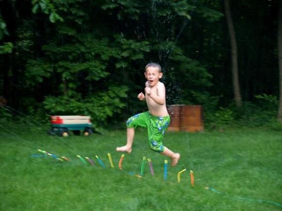 Chase playing in the sprinklers