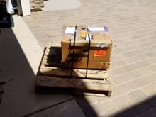 Shipping pallet with engine box secured to it.