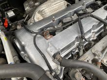 Wires relaxing leisurely on the burning hot valve cover. Please don't melt.