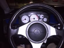White gauge cluster with dark blue and light blue lighting. Supposed to be green and blue lol.