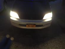 My stock headlights with green parking light