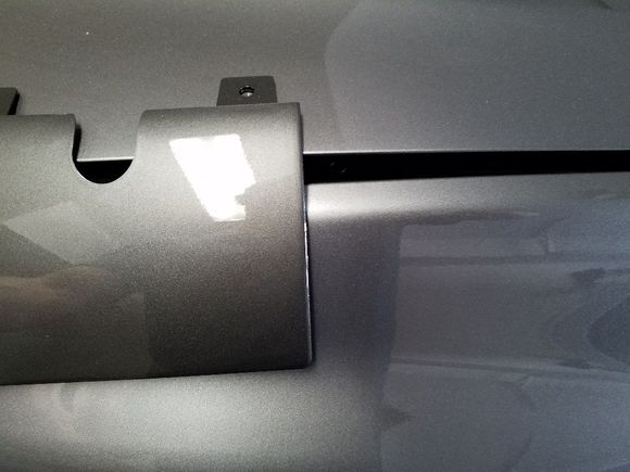 This is the tow hook cover for the JDM Evo 8/9 rear bumper.  I have not seen anyone post a picture of it against a graphite grey evo to show the difference in color.  This has been posted before, but I thought I would reiterate.  The diffuser portion of a jdm rear is not graphite grey, it is actually eisen grey mica (a02)