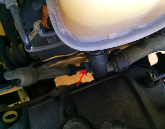 The arrow shows the oxidation of the metal knuckle at this steering joint from the coolant dropping down onto it.