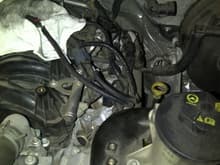 took air intake bracket off, and pulled the power steering bracket back slightly.  Also removed PCV hose on drivers side.