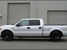 Lowered with 2wd F150 stock strut/springs and 2" shackles in the rear with 22" F150 Limited wheels powdercoated black.