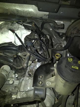 took air intake bracket off, and pulled the power steering bracket back slightly.  Also removed PCV hose on drivers side.