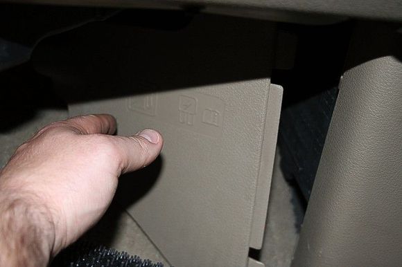 Step 5: Remove the fuse box cover and place it out of the way.