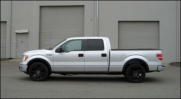 Lowered with 2wd F150 stock strut/springs and 2" shackles in the rear with 22" F150 Limited wheels powdercoated black.