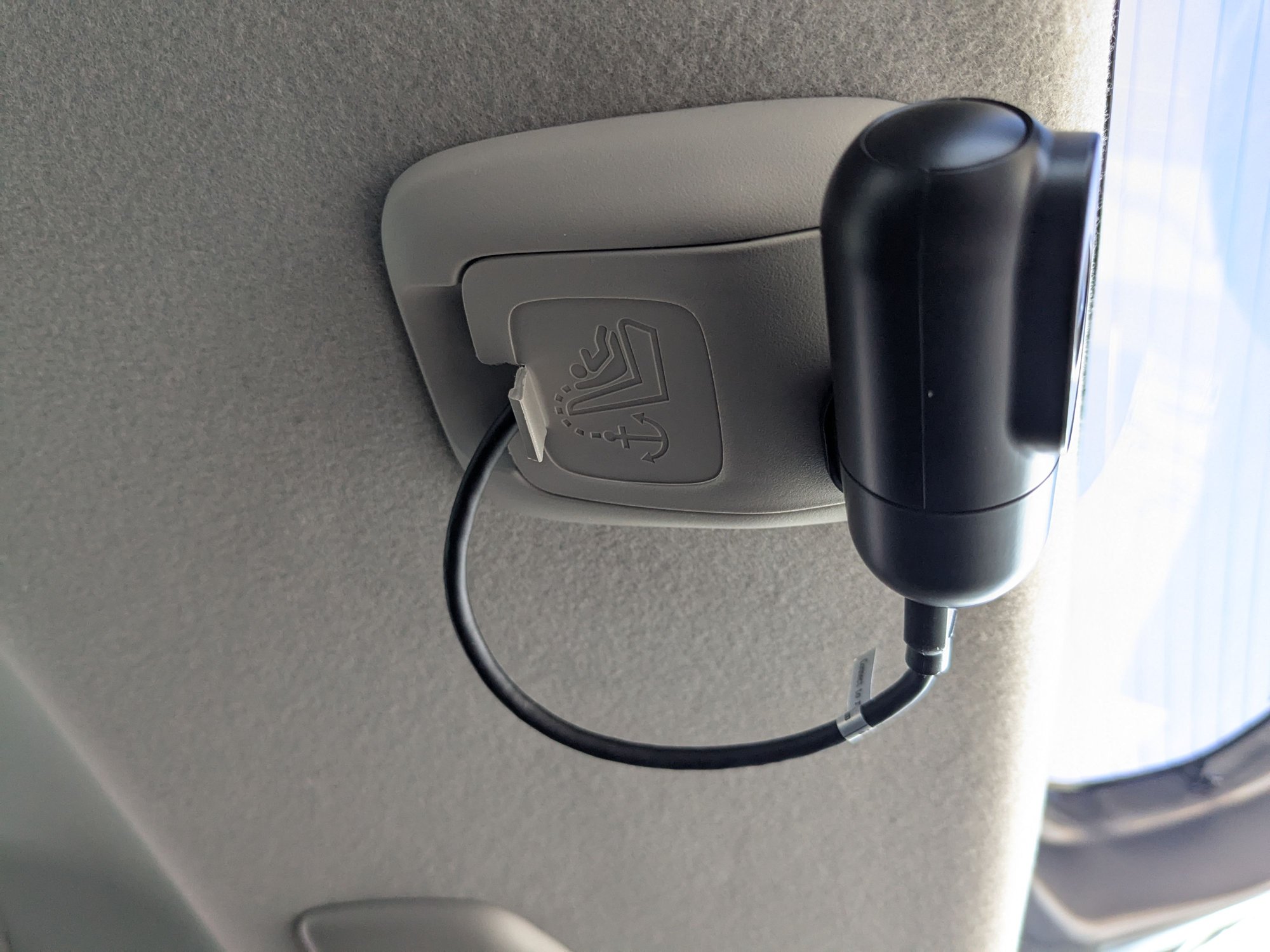 Figure 15 - I routed the excess cable inside the headliner, then routed through just enough slack for the cable to bend through the anchor point hole and into the camera. I used whatever adhesive the camera came with. If you notice, I also had to notch a bit of the plastic cover off the anchor point cover so the cable would be so stressed out. Up to you if you care about that kind of thing.