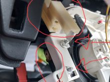 Top left view of switch with wire clip (top) and the switch (lower) circled and switch bolts with arrows