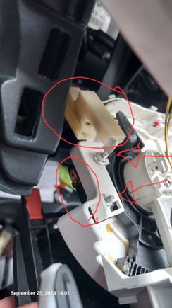 Top left view of switch with wire clip (top) and the switch (lower) circled and switch bolts with arrows