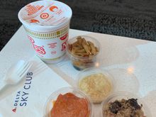 There was a bartender for alcoholic beverages but most soft drinks and water were self-serve from the machines. They had some veggie ramen in a cup as well as some regular instant noodles..