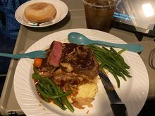 Flat iron steak with polenta, carrots, green beans, sauce, and crispy onions for dinner. They do medium rare very well. 
