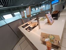 Sorry about the large size. Left to right: Bread with cheese, bread with salami (calling these "sandwiches" would be the highest insult to sandwiches) and a "shot" of fruit pieces. Coffee or chocolate from the "multi-drinks-machine" and the same goes for the 2 kinds of juices offered. 