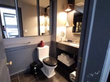 Bathroom, note chipped paint and cheap trash can with stickers still on it.