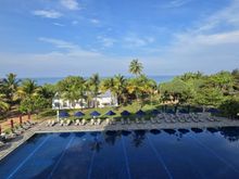 View from the junior suite balcony of the main resort pool and looking out to sea