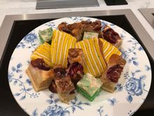 Assortment of cakes : the yellow stripes are banana spekkoek and the green stripes 