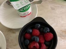 Berries, yogurt, sparkling water and an Americano.