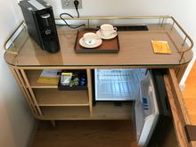 Minibar and coffee machine.
Note the machine is not Nespresso but an Leysieffer. And therefore uses different cups! Also it is an combined coffee maker and watercoocker, hence no sperate kettle.