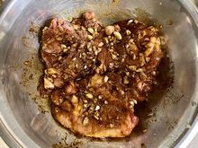 Chicken thighs marinated in chopped garlic and spices. 