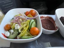 Salad with sliced cucumbers, tomatoes, banana peppers, and beets with some kind of tapenade based dressing.  Tasty but a little salty from the tapenade.

