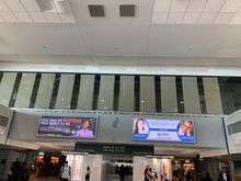 On walkway belt going towards low numbered gates in Concourse A. 