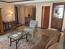 Living room seen towards entrance vestibule, the door on the right leads to the airing cupboard complete with iron and biard