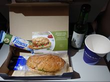 A3609, economy - hummus, rocket, and sundried tomato wholegrain baguette; Nestlé wholegrain fitness bar; white wine