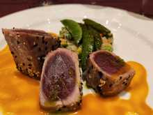 Sesame crusted tuna (prepared medium rare; quinoa & vegetable cake, baby bok choy, red pepper & miso sauce)