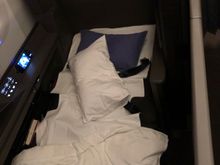The flight attendants woke me up about 2 hours before landing, and it was only now that I realized that there are actual doors that slide closed to the suite! I rushed to set up a picture before they came back to clean up the bed itself.