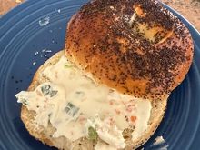 Fresh just baked Poppy seed bagel with their veggie cream cheese. Eaten the way it was meant to be - untoasted. Crisp on the outside, chewy inside. Bagel perfection. 
