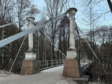 suspension bridge above waterfall