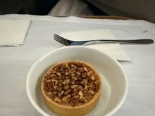The pecan tart was served cold on this flight, and though I needed the skills of a surgeon to cut it, I still found it tasty. 